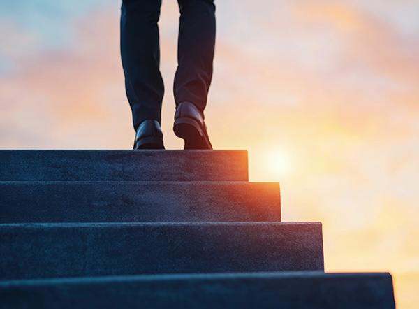 A determined individual climbing the stairs of career success